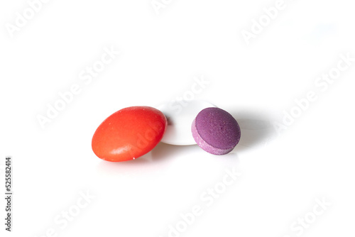 Image of different pills red, white, violet on white background with shadows 