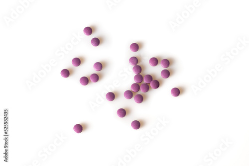 Image of violet pills isolated with shadows