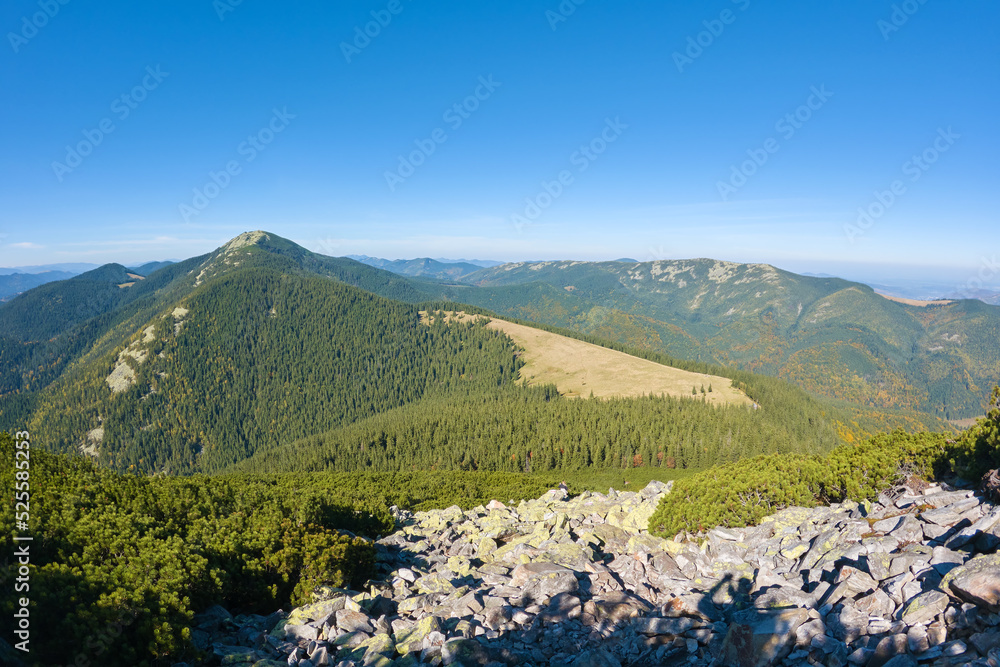 Rocky mountain hillside with big stone boulders on sunny day