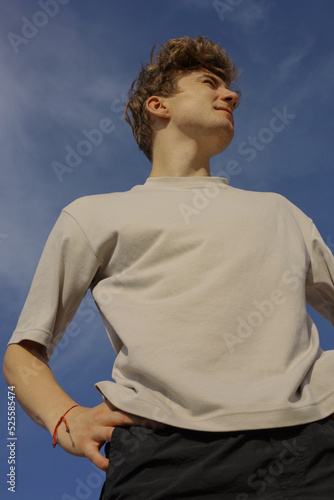 man squinting against the sky