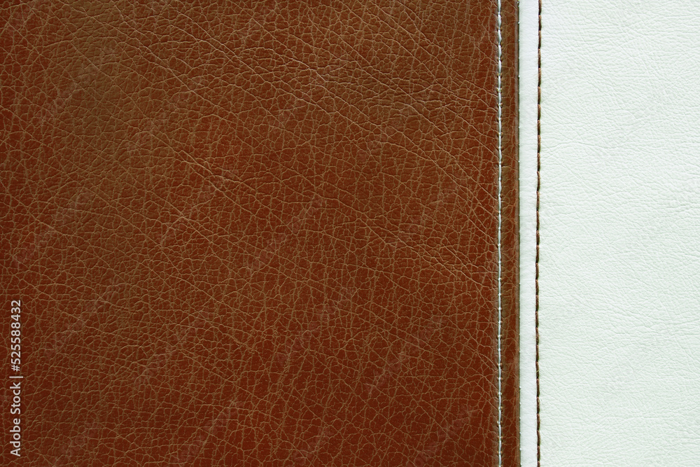 Fototapeta premium Natural, artificial brown and white leather texture background with vertical decorative seam. Material for sport items, clothes, furnitre and interior design. ecological friendly leatherette.