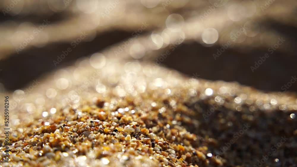Close-up of sand pouring slowly, against the background of golden bokeh, sunset light. Slow motion. Close-up of sand pouring slowly, against the background of golden bokeh, sunset light. Slow motion.