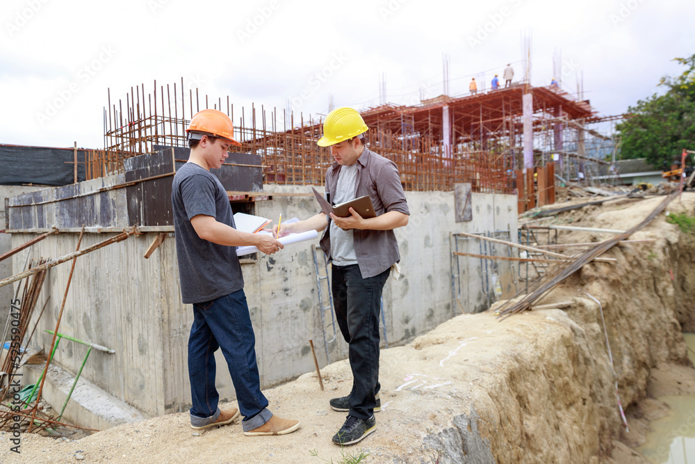 Construction concept of Engineer and Architect working at Construction Site with blue print Construction concept of Engineer and Architect working at Construction Site with blue print