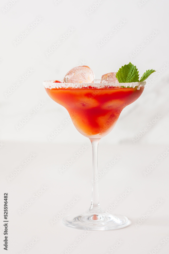 Alcoholic drink with tomato juice in a glass with ice close-up on a white background Alcoholic drink with tomato juice in a glass with ice close-up on a white background