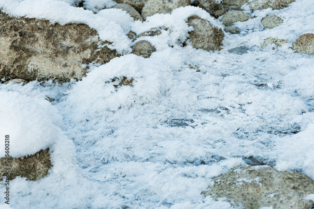 Fluffy hoarfrost on gray cobblestones. Condensation from sharp cold snap, snow on stone wall. Winter weather outdoors Fluffy hoarfrost on gray cobblestones. Condensation from sharp cold snap, snow on stone wall. Winter weather outdoors