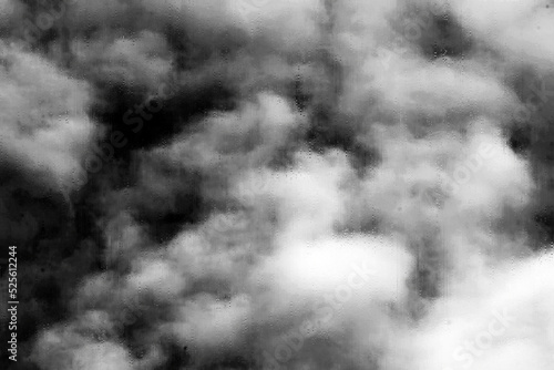 Storm clouds seen through a window wet with rain