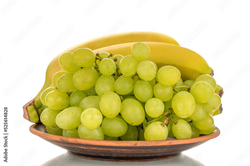 One bunch of white grapes Quiche mish and bananas on a ceramic plate, close-up, isolated on a white background. One bunch of white grapes Quiche mish and bananas on a ceramic plate, close-up, isolated on a white background.