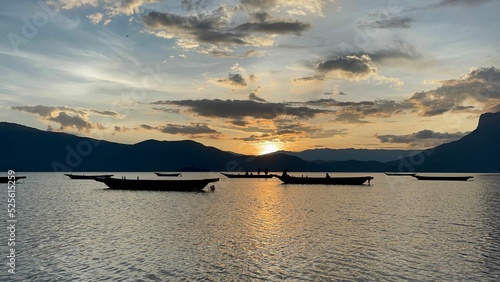 Scenic Lugu Lake with empty boats at sunset in Yanyuan County, China photo