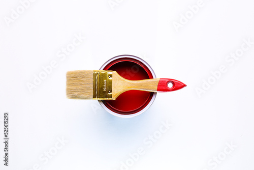 red open paint can with brush on it isolated on white background