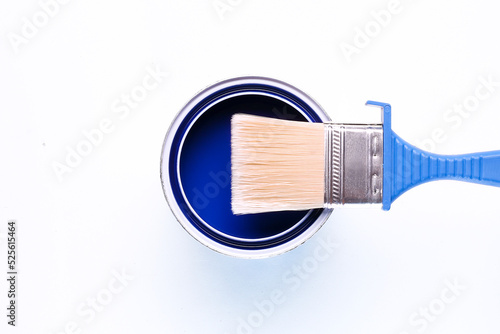 blue open paint can with brush on it isolated on white background