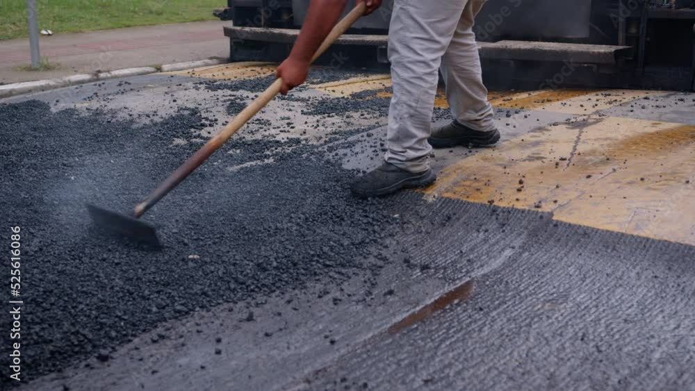 Fresh asphalt road with workers and paving machines, road construction process Fresh asphalt road with workers and paving machines, road construction process
