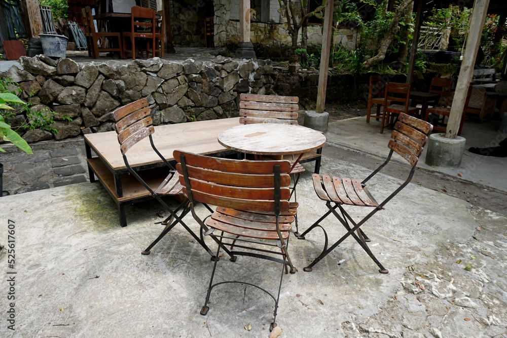 set of wooden tables and chairs in the yard