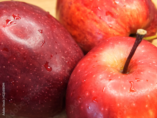 Three big red apples, closeup shot. Appetizing ripe fruits, macro.