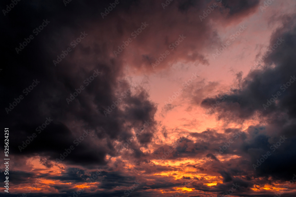 Dramatic sunset with orange clouds.
