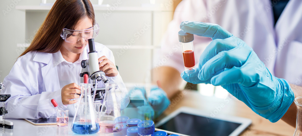 lab technician assistant analyzing a blood sample in test tube at laboratory with microscope. Medical, pharmaceutical and scientific research and development concept.
lab technician assistant analyzing a blood sample in test tube at laboratory with microscope. Medical, pharmaceutical and scientific research and development concept.