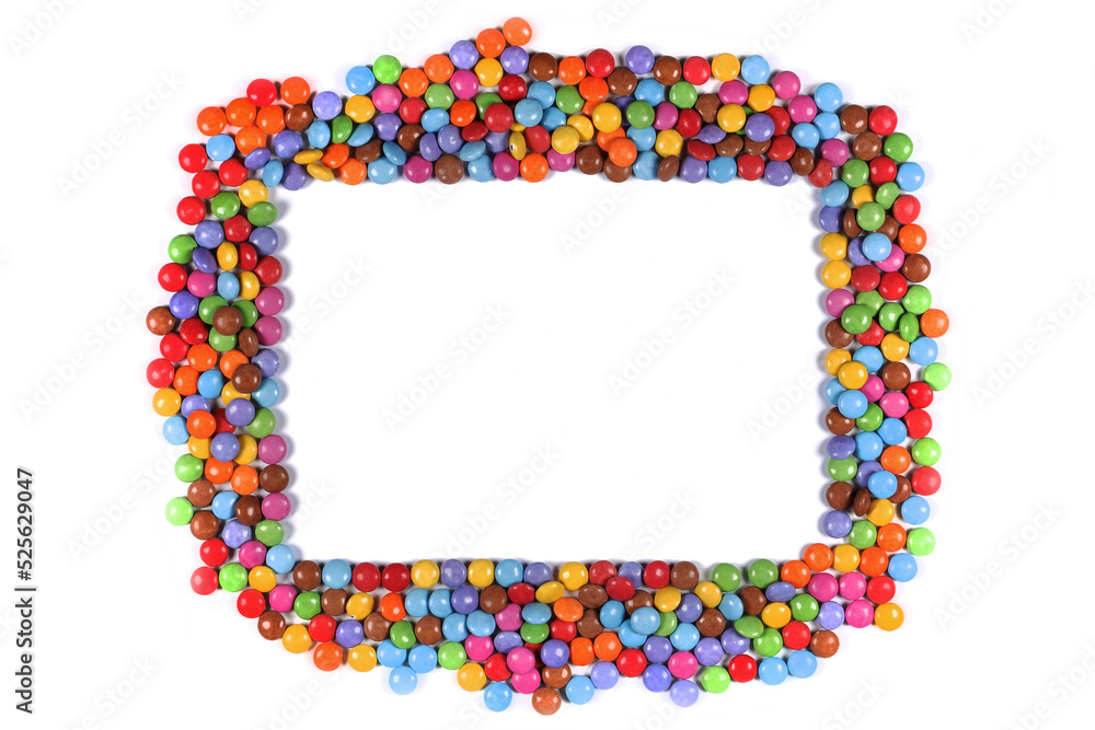 Frame border of multi coloured halloween candy sweets on white