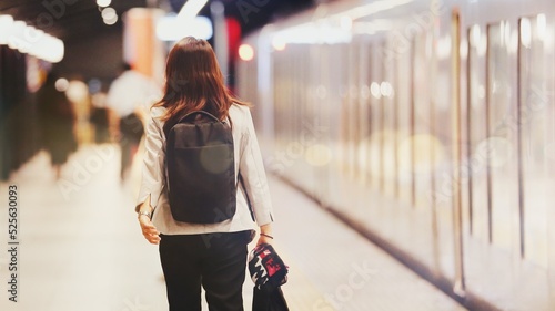 Young woman walking at train station / Travel and Business concept