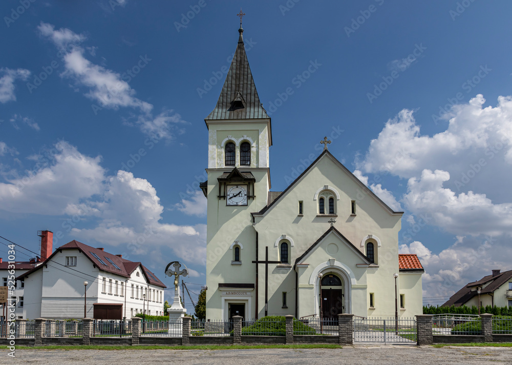 Roman Catholic Church of St. Bartholomew in Hażlach against the background of a blue sky and clouds 