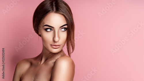 Close up portrait of tender cute gorgeous gentle perfect facial skin girl isolated on rose background