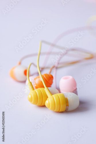 close up of colorful earphone on white background 