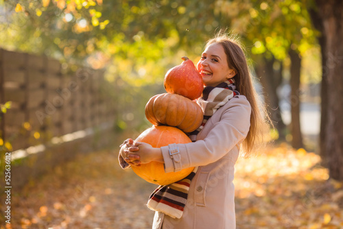 Portrait of happy smile woman with pumpkins in hand.
