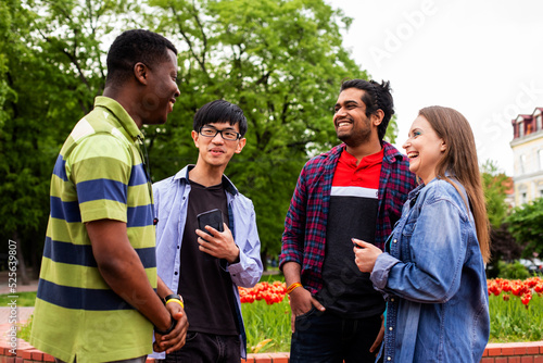 Outdoor communication between joyful multiracial college students