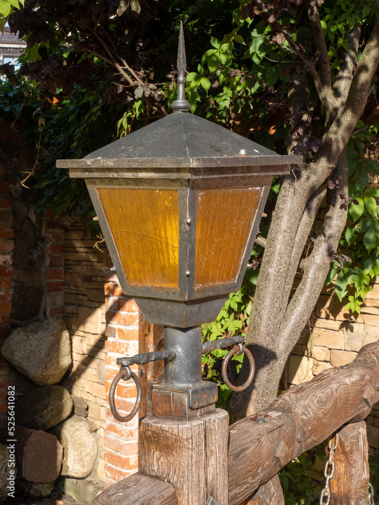 Fototapeta premium ship lantern against the background of trees, iron