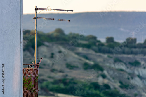 Close Up of Television Antennas mounted on a Balcony in Italy on Blurred Backgeround photo