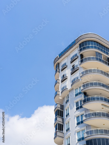 Exterior of a high-rise apartment building. Large balconies.
