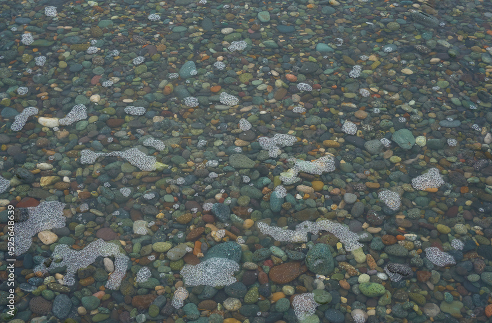Pebble beach flooded with water after high tide Pebble beach flooded with water after high tide