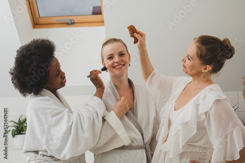 Obraz na plátne The happy girlfriends at the spa beautify each other