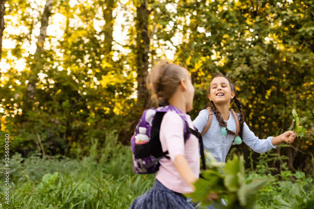 Fototapeta premium schoolgirls among the autumn landscape.