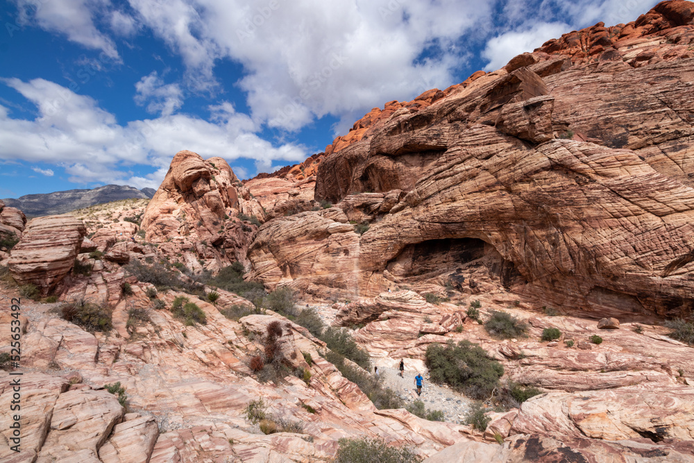 Hiking on a trail through rock formations at Red Rock Canyon National Conservation Area.