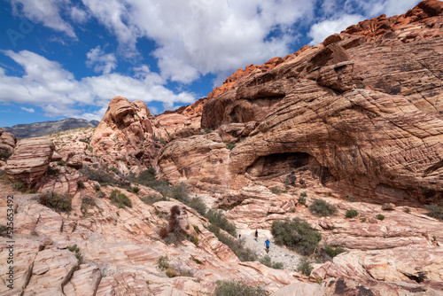 Hiking on a trail through rock formations at Red Rock Canyon National Conservation Area. © Lynda