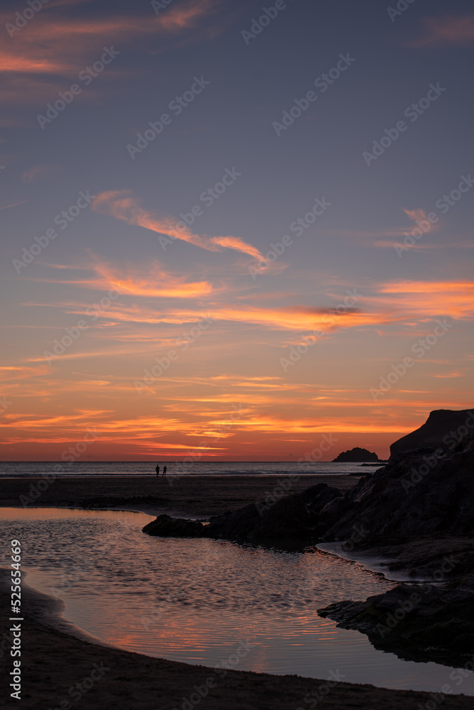 sunset over the sea beach polzeath cornwall england coast cliff silhouette water people rock island sunset over the sea beach polzeath cornwall england coast cliff silhouette water people rock island