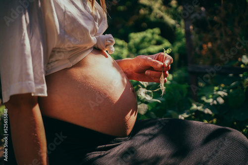 Pregnant woman with two sprouted plant is expecting