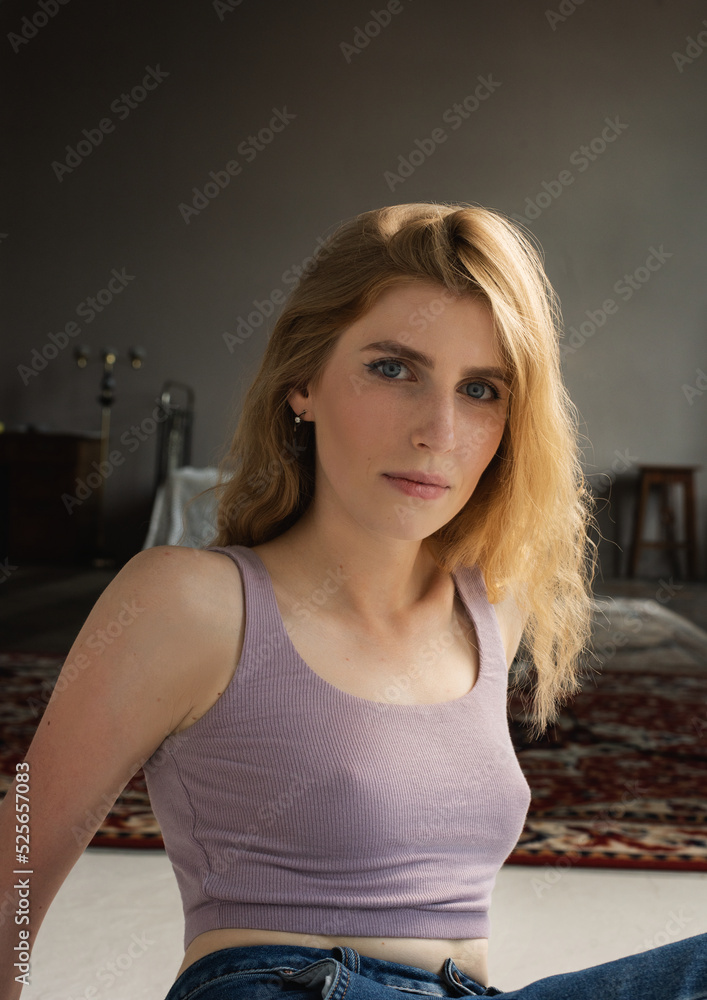 Fototapeta premium A girl in an atmospheric studio in a light key