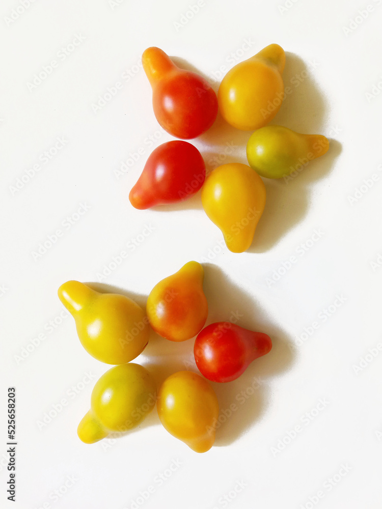 floral ornament made from yellow and red pear-shaped cherry tomatoes floral ornament made from yellow and red pear-shaped cherry tomatoes