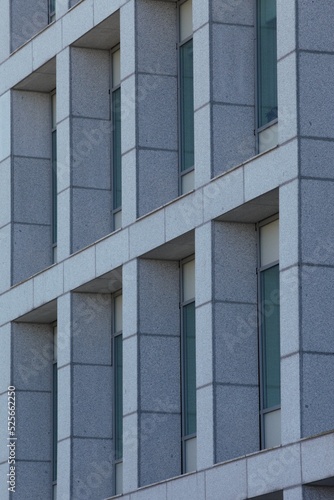 Photography Vertical shot of a gray building ventilated facade with green windows