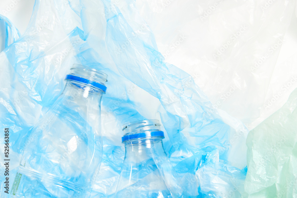 Plastic transparent disposable bottles over, green and blue wrinkled