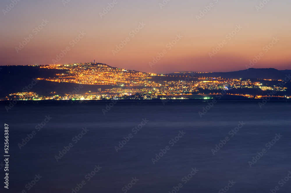 Fototapeta premium Lake Kinneret on the Sunset and the lights of Tiberias