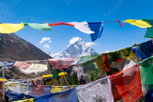 Kangtega mountain peak seen through colorful clothes hanging on a rope photo
