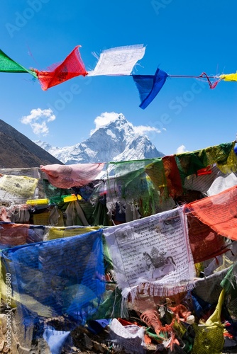 Kangtega mountain peak seen through colorful clothes hanging on a rope photo