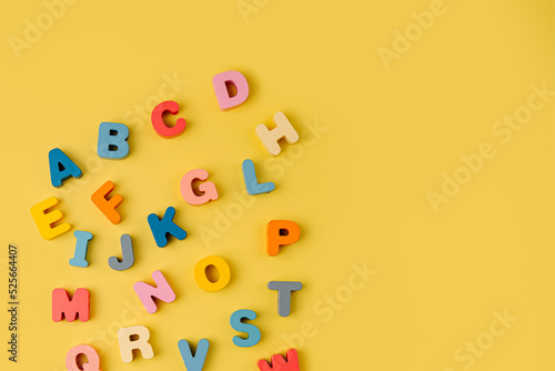Colorful letters of the alphabet on yellow background. Primary school or preschool, kindergarten. Educational game. Learning through play.