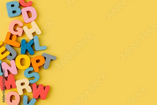 Colorful letters of the alphabet on yellow background. Primary school or preschool, kindergarten. Educational game. Learning through play. © igishevamaria