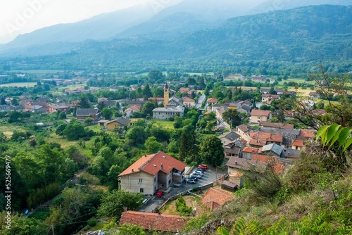 Aerial view of the village of Foresto with red-roofed houses and green trees photo