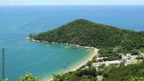 Drone shot of the greenery coastline of Laranjeiras Camboriu beach in Brazil with beautiful sea view photo