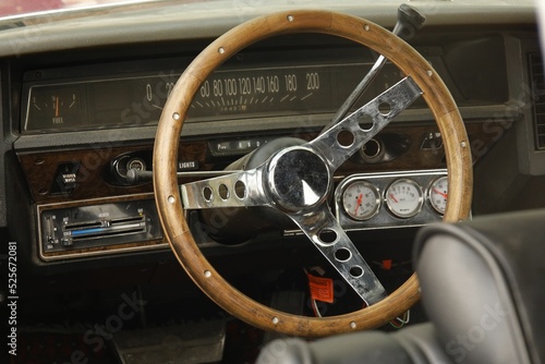 Closeup shot of a steering wheel of a vintage car on a car show photo