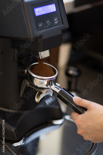 Espesso making. Hand holding the portafilter to fill up the grind coffee bean. The Basic Parameters of an Espresso.