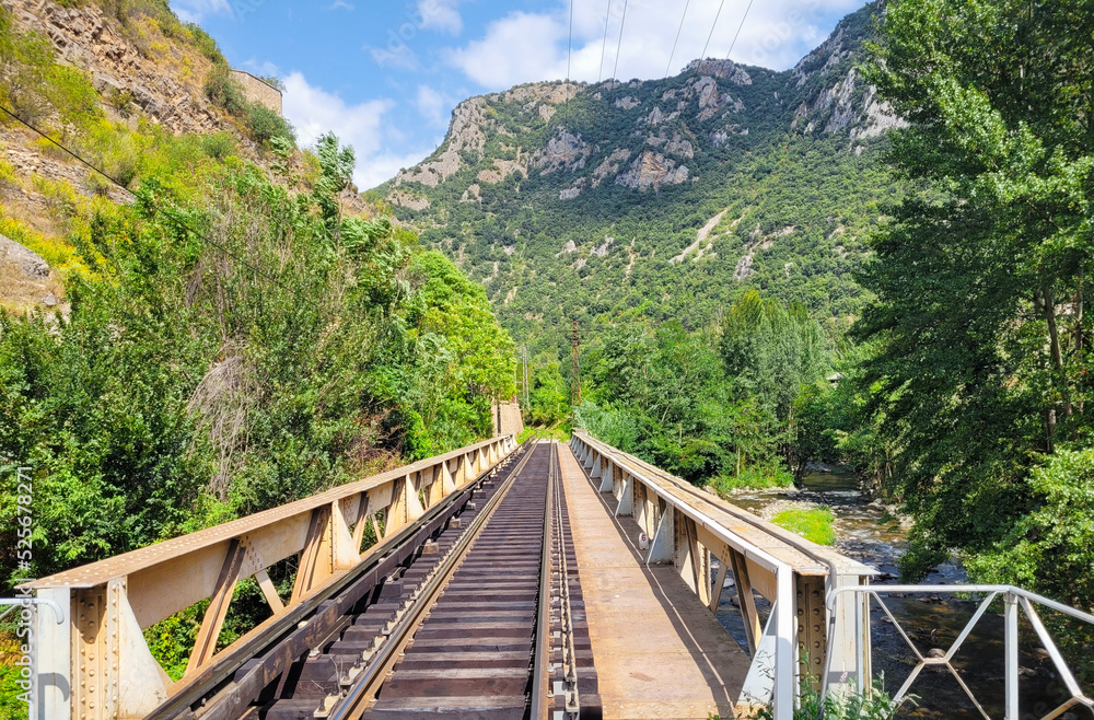 Villefranche de Conflent, France. Train tracks in nature. Nature landscape. Space for text. Villefranche de Conflent, France. Train tracks in nature. Nature landscape. Space for text.